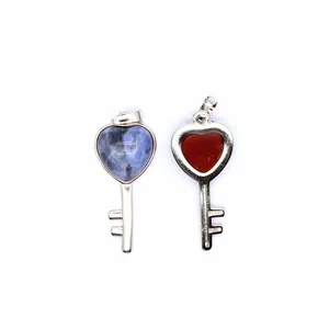 Detailed close-up view of heart-shaped key pendants featuring natural blue and red gemstones