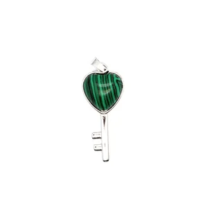 Detailed close-up of heart-shaped malachite key pendant with silver-toned metal frame