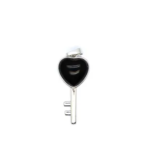 Detail view of a heart-shaped black stone key pendant on white background.