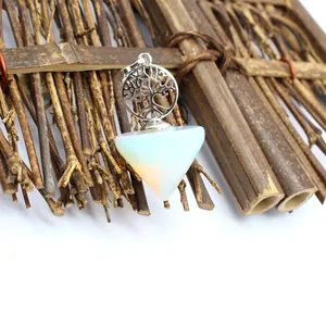 Detail of crystal Tree of Life pendulum pendant featuring a milky opalite cone stone