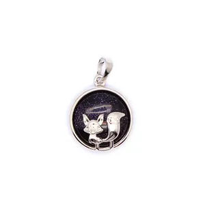 Close-up of a silver fox pendant with a sparkling starry blue sandstone background