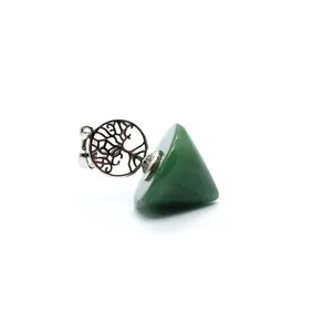 Macro view of a green crystal pendulum pendant featuring an intricate Tree of Life charm