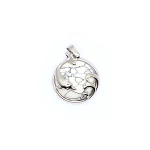 Macro detail of the silver dolphin and wave carving on a white marble texture pendant