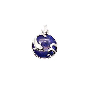 Detail view of a round blue stone pendant featuring a silver dolphin and wave motif