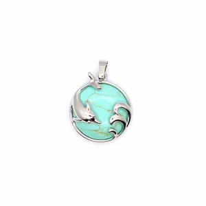 Close-up of silver dolphin and wave pendant with turquoise stone inlay