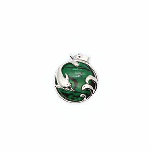 Intricate silver dolphin and ocean wave pendant with circular green patterned stone inlay