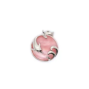Detail view of a silver dolphin pendant featuring a round pink aventurine gemstone piece.