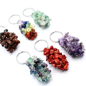 Detailed macro view of multiple natural crushed crystal stone keychains in vibrant colors