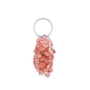 Close-up detail of natural pink crystal chip stone keychain and decorative bag charm