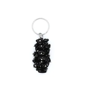 Close-up detail of a handmade black crushed crystal stone pendant keychain for bags.