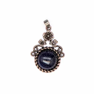 Dettaglio di un ciondolo floreale vintage con una scintillante pietra di arenaria blu
