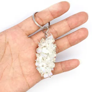Detailed close-up view of handmade crystal crushed stone keychain pendant held in hand