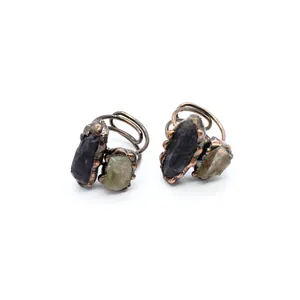 Close-up detail of individualistic raw labradorite stone rings with antique bronze spiral band
