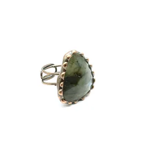 Detailed macro view of a natural labradorite stone ring in a vintage bronze beaded setting