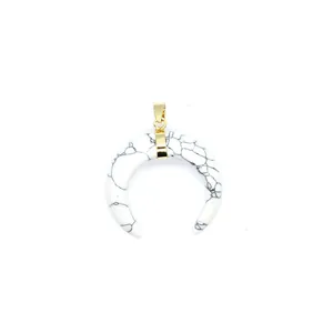 Detailed view of white horn-shaped pendant featuring black marble veins and gold-plated bail