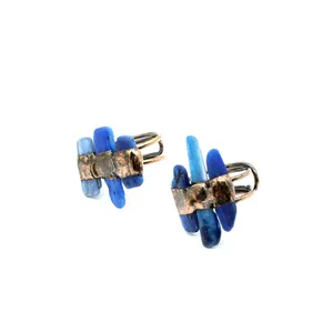 Macro view of raw blue stones on textured bronze open rings with rustic handmade design