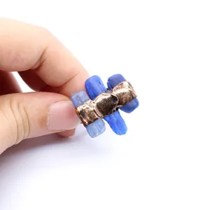 Detailed close-up view of a raw blue stone open ring with rustic copper metal finish