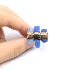 Close-up of raw blue gemstone adjustable ring with vintage copper textured setting