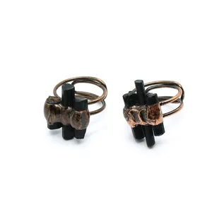 Detailed view of two vintage copper open rings featuring raw black labradorite stones