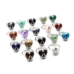Close-up detail of diverse heart-shaped natural stone rings in colorful variety.