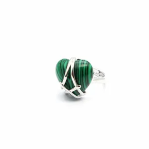 Detail view of a heart-shaped green striped stone ring with silver-tone criss-cross wrap.