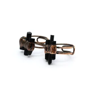 Detailed view of handcrafted vintage copper wire-wrapped rings with black raw stones