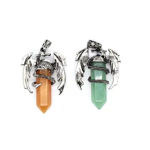 Detailed view of two dragon wrapped crystal hexagonal column pendants in orange and green