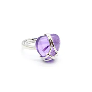 Close-up of heart-shaped purple stone ring with adjustable silver-colored band