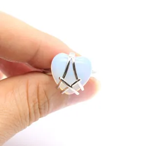 Detailed macro view of heart-shaped opal ring with unique Masonic compass setting