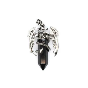 Close-up of gothic silver dragon pendant wrapped around black hexagonal crystal column