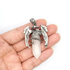 Detail view of a silver dragon pendant wrapped around a pink crystal pillar