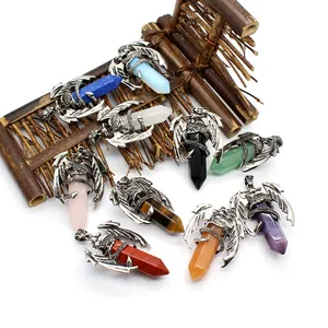 Macro view of vintage flying dragon charms wrapped around hexagonal crystal prisms