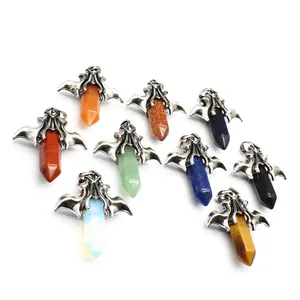 Close-up detail of vintage flying dragon pendants with various hexagonal crystal stones