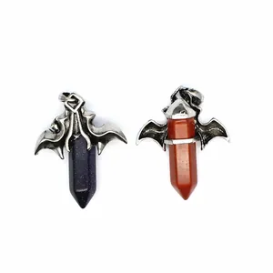 Detailed close-up of gothic dragon bat wing pendants with hexagonal stone pillars