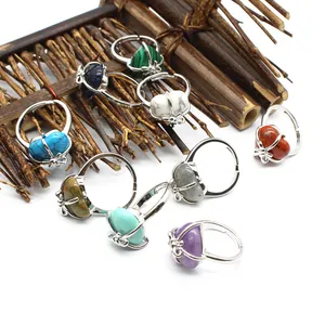 Detail view of colorful heart-shaped natural stone rings on bamboo mat
