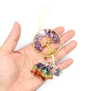 Close-up of handmade Chakra Tree of Life car hanging ornament with colorful crystals