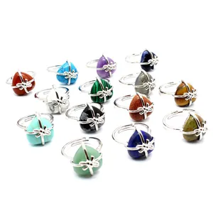 Detailed view of various heart-shaped natural stone rings with silver bow settings