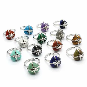 Close-up detail of assorted natural stone heart rings featuring adjustable silver bands