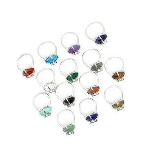 Detailed view of silver heart-shaped rings featuring a variety of colorful natural gemstones
