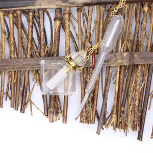 Close-up of a clear rhombus fluorite perfume bottle pendant necklace with a plastic dropper.