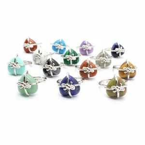 Collection of various colorful heart-shaped natural stone rings with silver bow design