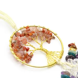 Macro shot of a handmade Tree of Life car charm with natural healing crystal stones.