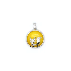 Detail of round fox pendant with yellow volcanic stone and silver finish