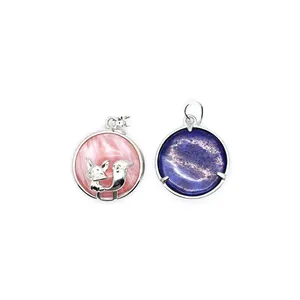Close-up view of a pink fox pendant and a blue round volcanic stone pendant necklace