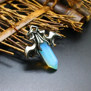 Close-up of gothic dragon wing pendant with glowing opal hexagonal crystal pillar