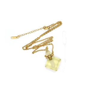 Close-up detail of a rhombus fluorite perfume bottle pendant necklace with dropper tool