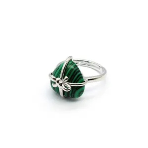 Close-up view of a silver heart ring featuring a striped green malachite stone.