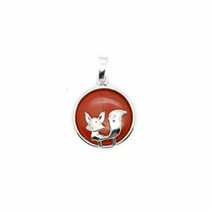 Close-up of the silver fox design set against a red natural stone in a round pendant