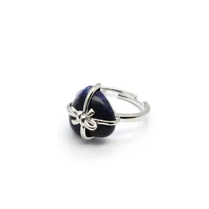Silver-toned adjustable bow ring featuring a dark heart-shaped natural stone detail