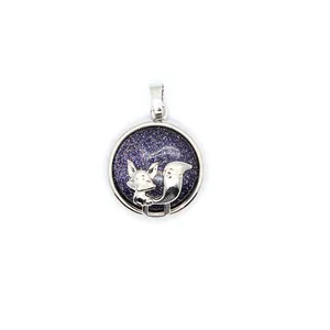 Close-up detail of a silver fox pendant on a circular blue galaxy volcanic stone base